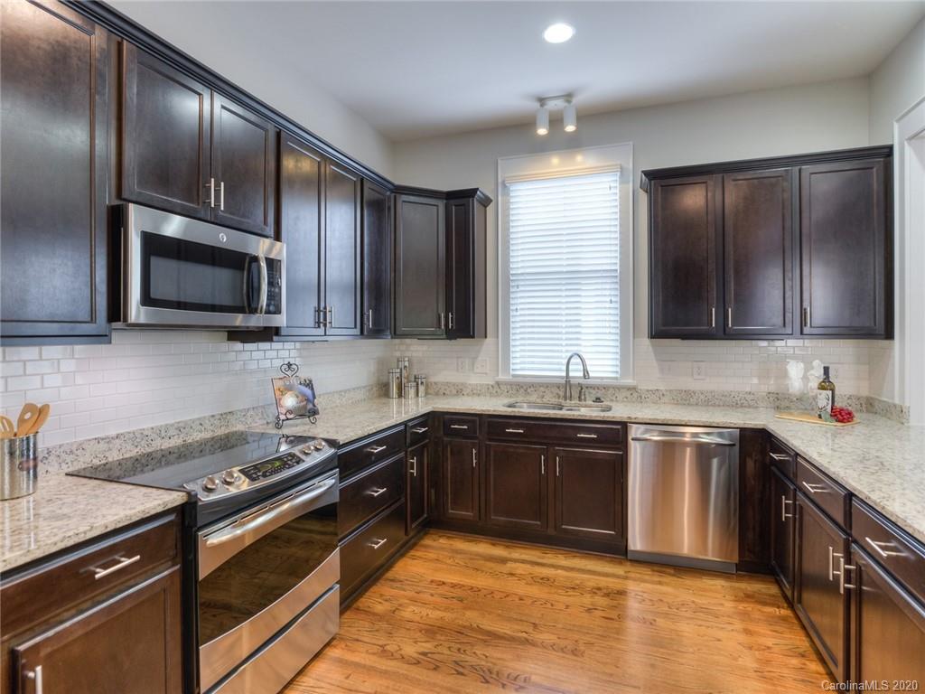 209 Coneflower Place Fort Mill, SC 29708 - Photo 19 of 48 a kitchen with stainless steel appliances granite countertop a sink stove microwave and refrigerator