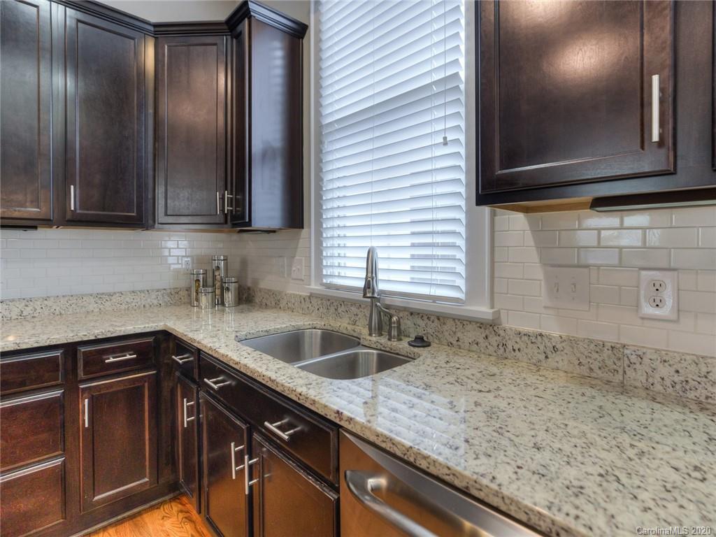 209 Coneflower Place Fort Mill, SC 29708 - Photo 20 of 48 a kitchen with granite countertop a sink and cabinets