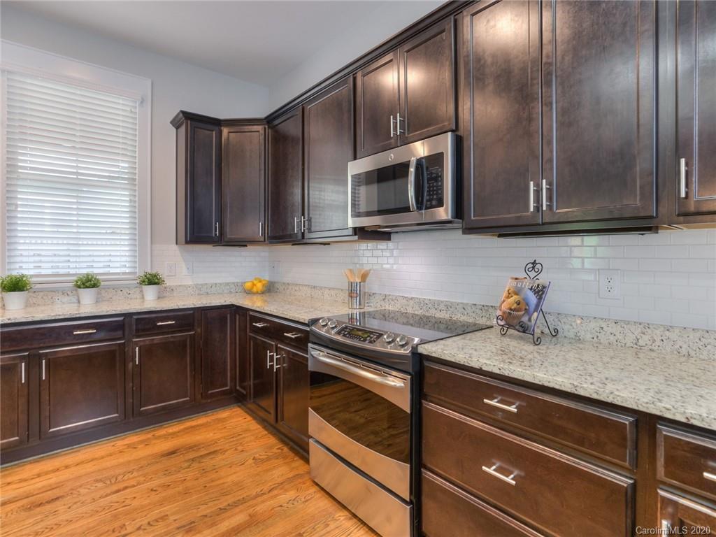 209 Coneflower Place Fort Mill, SC 29708 - Photo 21 of 48 a kitchen with granite countertop stainless steel appliances and cabinets