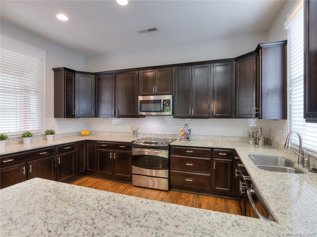 209 Coneflower Place Fort Mill, SC 29708 - Photo 24 of 48 a kitchen with stainless steel appliances granite countertop a sink stove and microwave