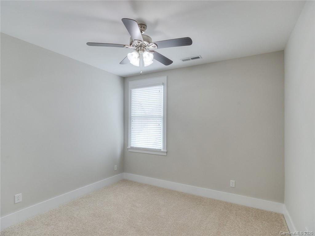 209 Coneflower Place Fort Mill, SC 29708 - Photo 30 of 48 an empty room with windows and fan