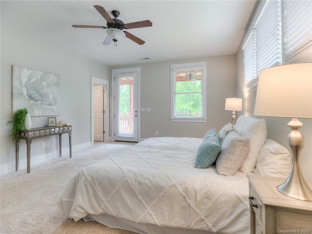 209 Coneflower Place Fort Mill, SC 29708 - Photo 39 of 48 a bedroom with a bed and a chandelier