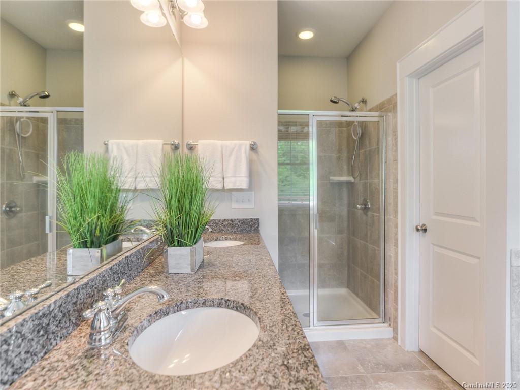 209 Coneflower Place Fort Mill, SC 29708 - Photo 41 of 48 a bathroom with a granite countertop sink a shower and a mirror
