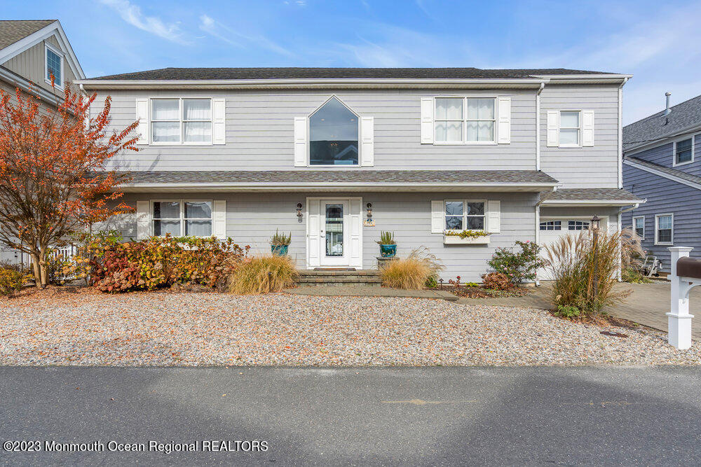 304 Cutter Lane Mantoloking, NJ 08738 - Photo 2 of 54 a front view of a house with a yard and garage