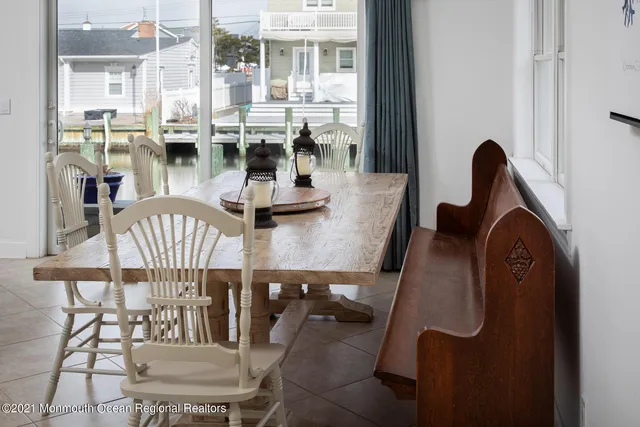 a dining room with furniture a rug and a chandelier