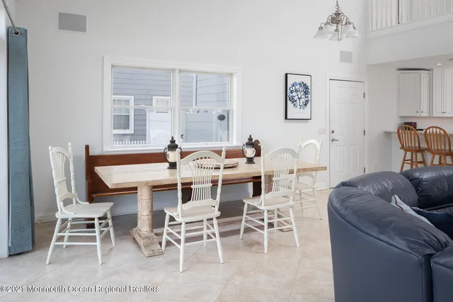 a kitchen with dining table and chairs