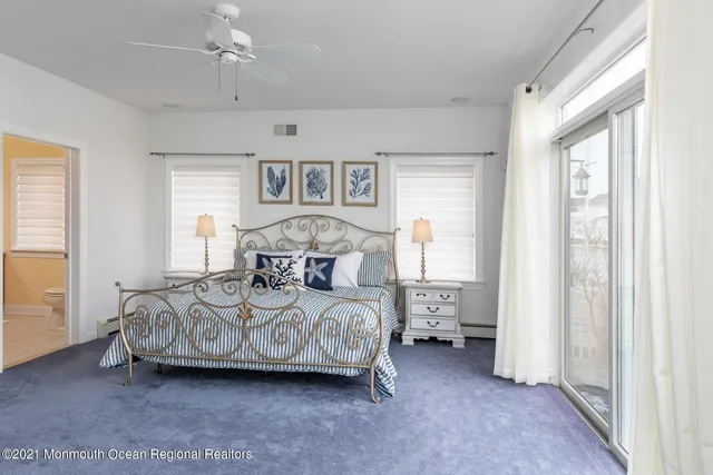 a bedroom with a bed and a table with wooden floor