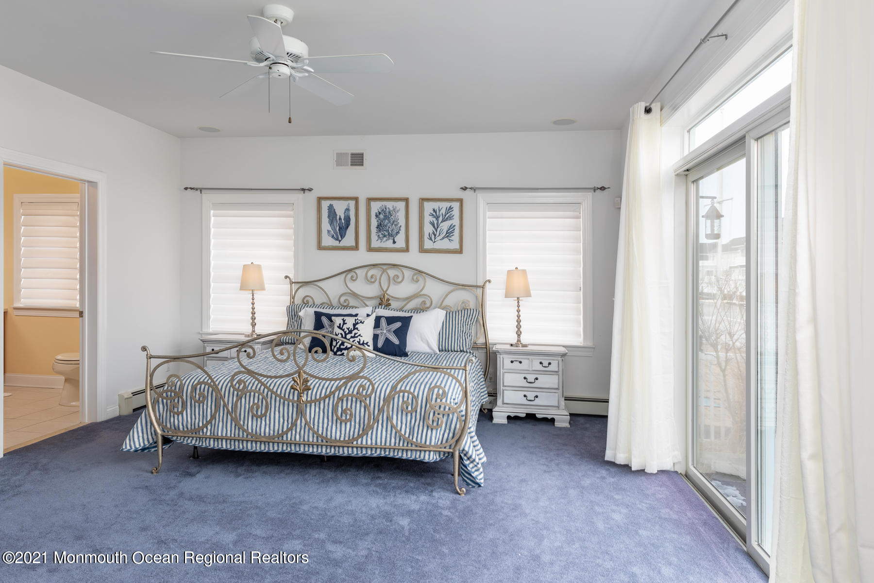 304 Cutter Lane Mantoloking, NJ 08738 - Photo 27 of 54 a bedroom with a bed and a chandelier