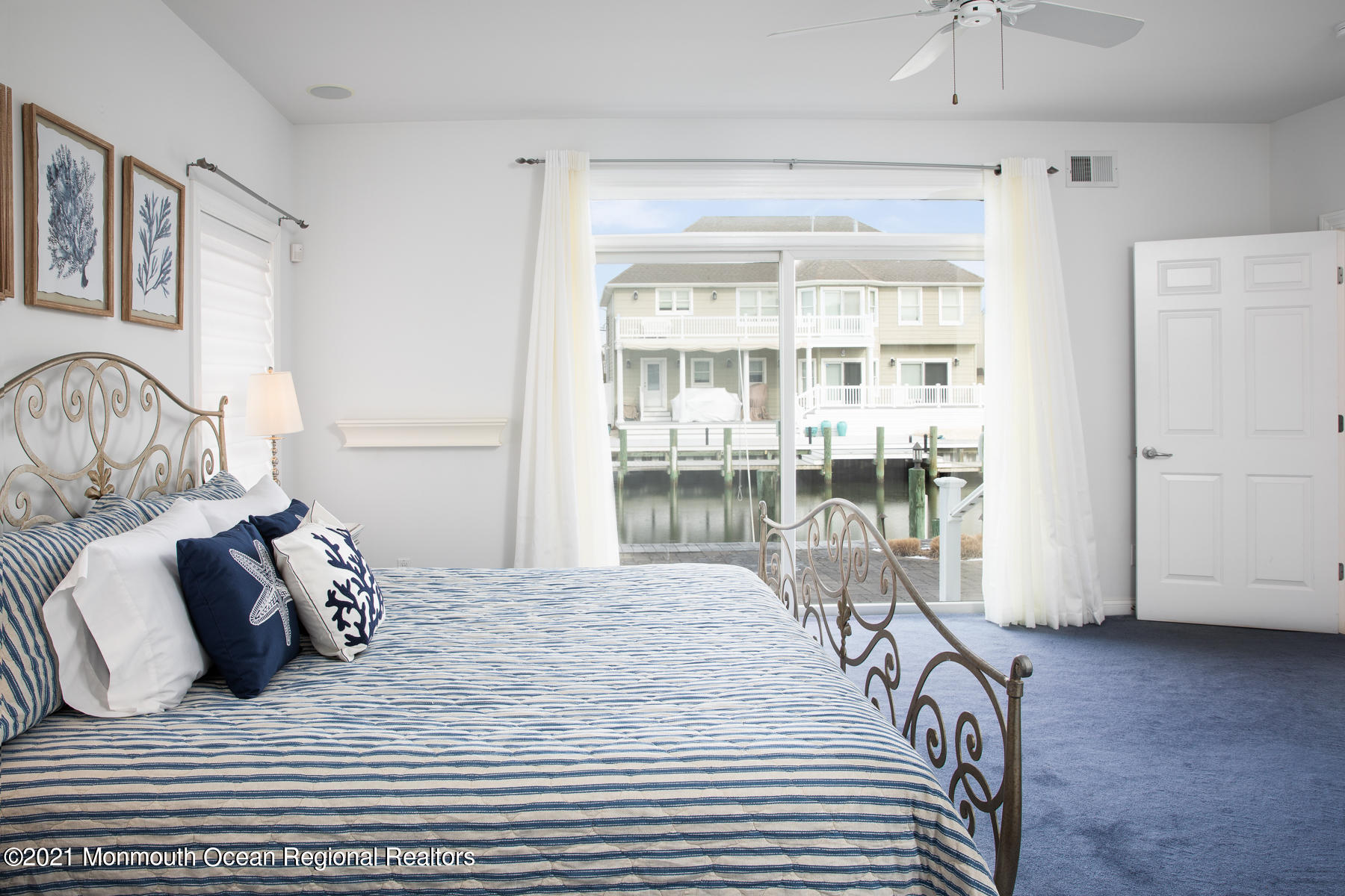 304 Cutter Lane Mantoloking, NJ 08738 - Photo 28 of 54 a bedroom with a bed and a table with wooden floor