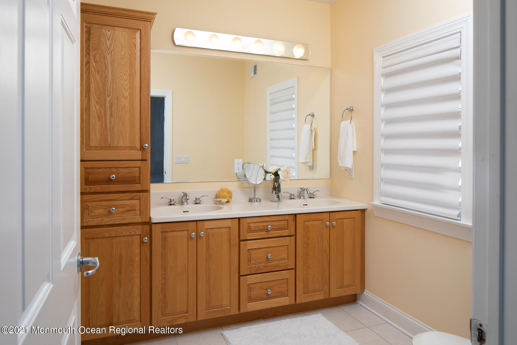 304 Cutter Lane Mantoloking, NJ 08738 - Photo 29 of 54 a bathroom with a sink and a mirror