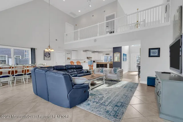 a living room with furniture and a dining table