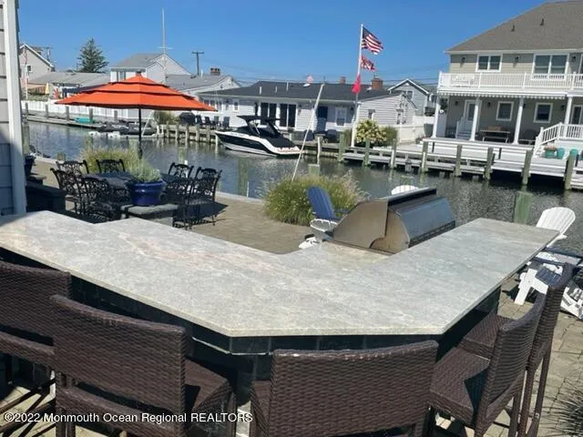 a view of a patio with table and chairs