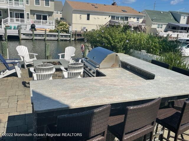 304 Cutter Lane Mantoloking, NJ 08738 - Photo 48 of 54 a view of a patio with table and chairs