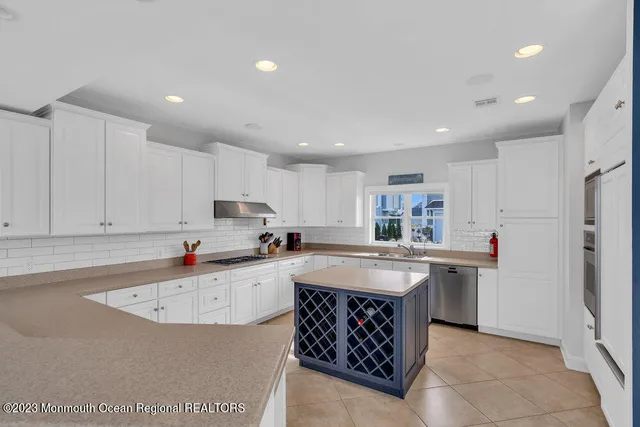 a kitchen with refrigerator and cabinets