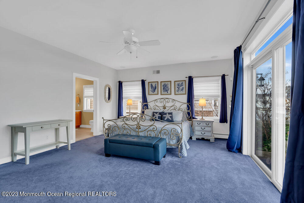 304 Cutter Lane Mantoloking, NJ 08738 - Photo 8 of 54 a spacious bedroom with a bed and large window