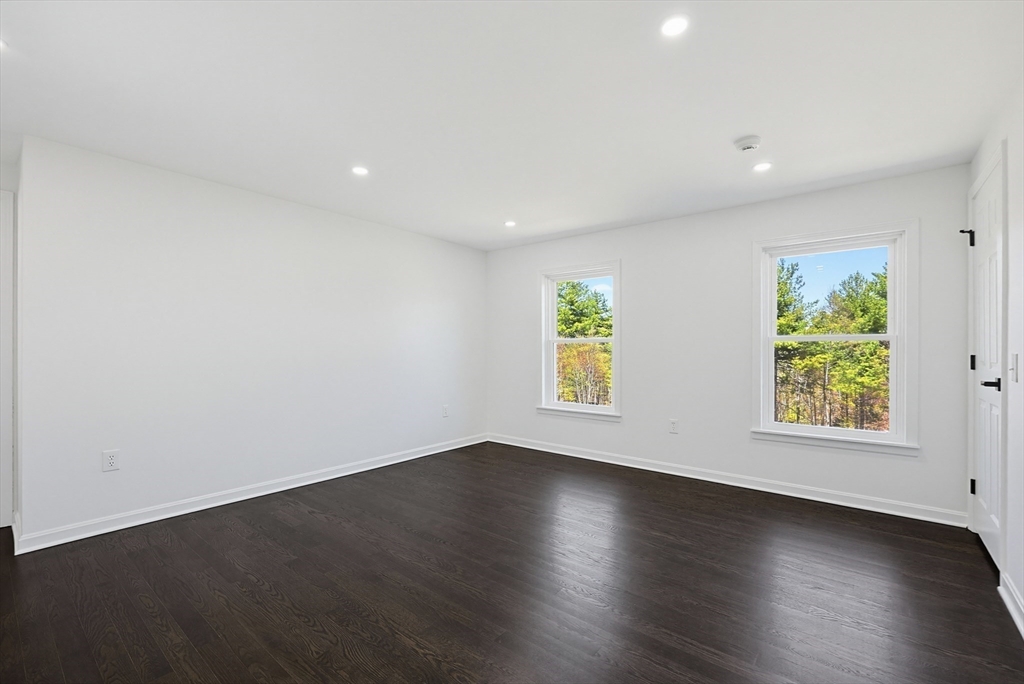 175 Pleasant Street Upton, MA 01568 - Photo 23 of 39 a view of an empty room with a window and wooden floor