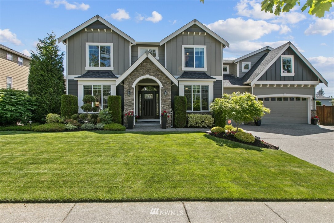 21703 31st Drive Southeast Bothell, WA 98021 - Photo 2 of 34 a front view of a house with a yard
