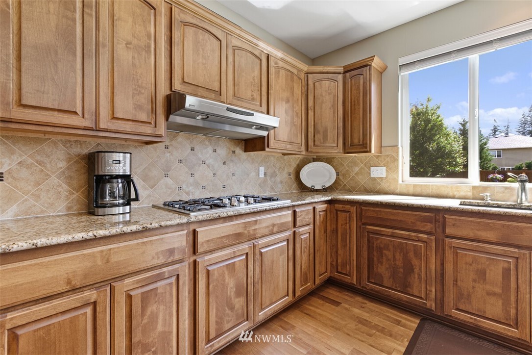 21703 31st Drive Southeast Bothell, WA 98021 - Photo 11 of 34 a kitchen with stainless steel appliances granite countertop a sink stove and cabinets
