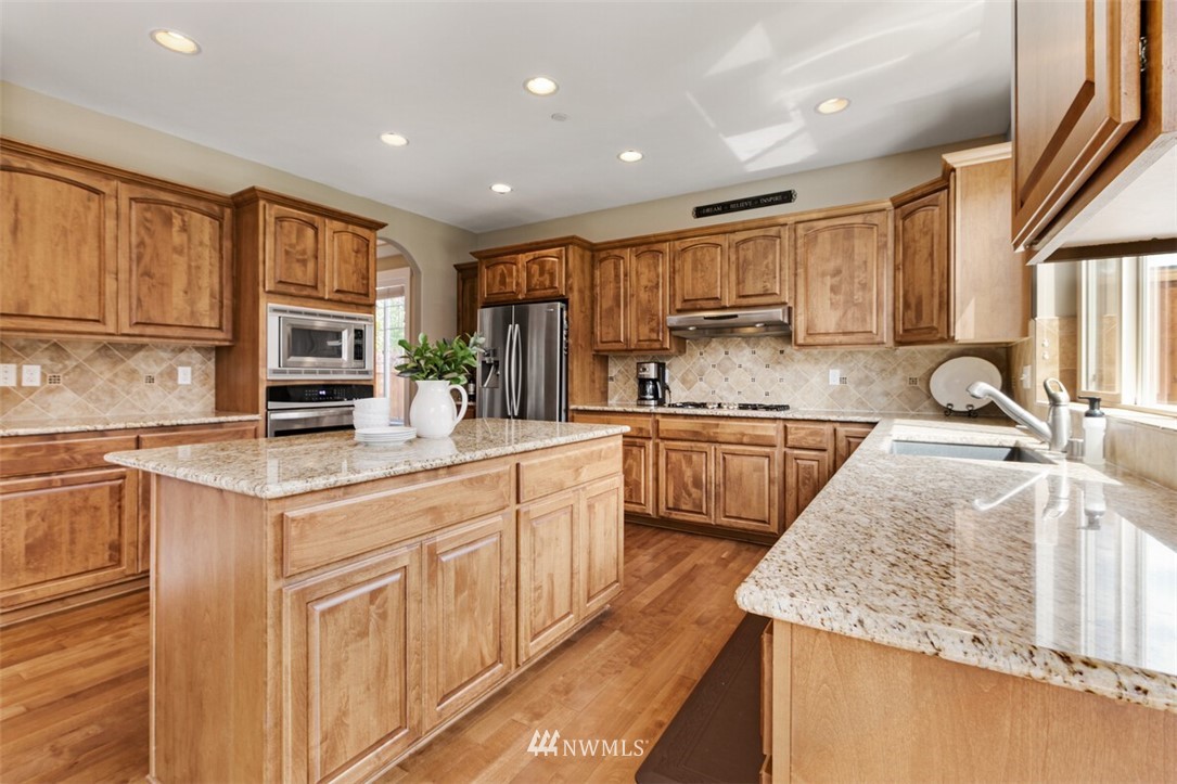 21703 31st Drive Southeast Bothell, WA 98021 - Photo 13 of 34 a kitchen with stainless steel appliances granite countertop a sink stove and cabinets