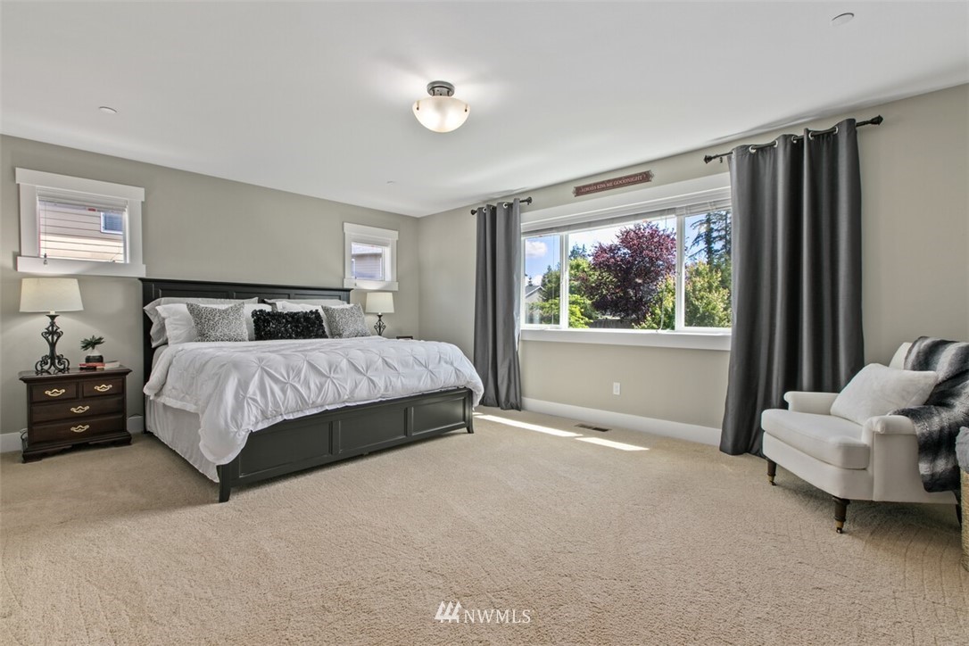21703 31st Drive Southeast Bothell, WA 98021 - Photo 17 of 34 a bedroom with a bed and glass window