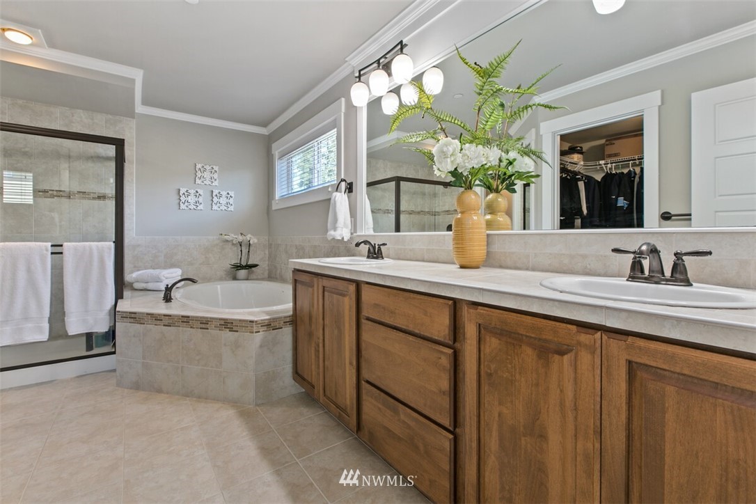 21703 31st Drive Southeast Bothell, WA 98021 - Photo 18 of 34 a bathroom with a granite countertop sink mirror and a bathtub