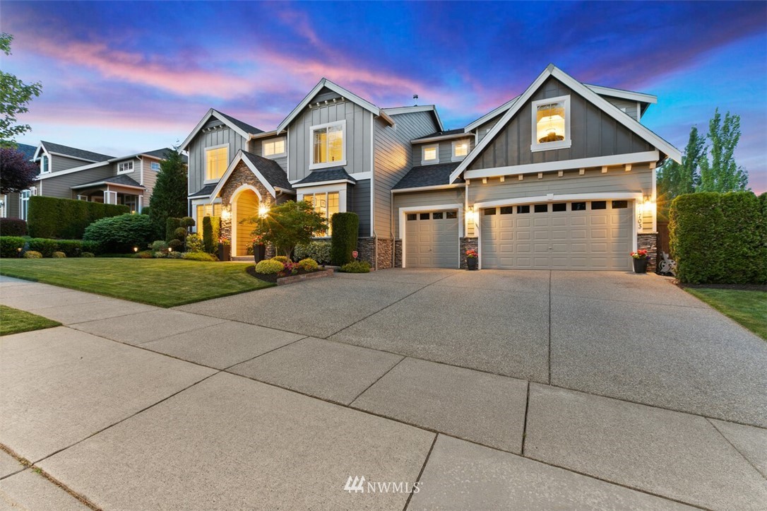 21703 31st Drive Southeast Bothell, WA 98021 - Photo 3 of 34 a front view of a house with a yard and garage