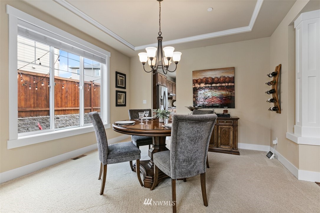 21703 31st Drive Southeast Bothell, WA 98021 - Photo 7 of 34 a dining room with furniture a chandelier and window