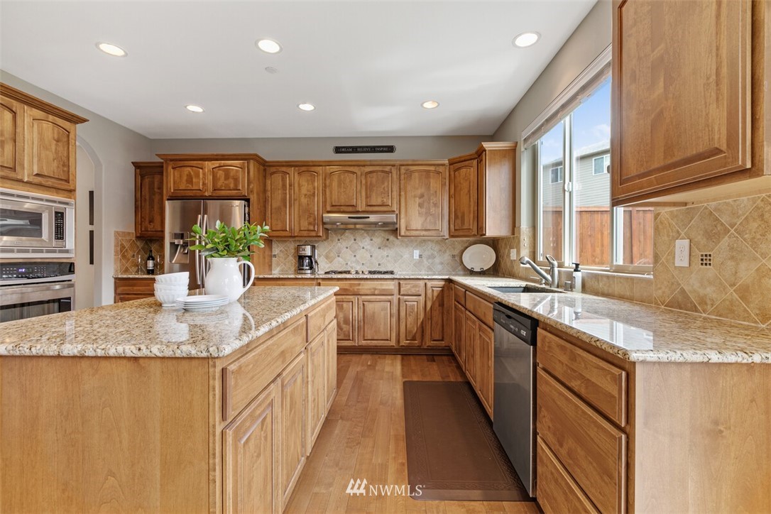21703 31st Drive Southeast Bothell, WA 98021 - Photo 10 of 34 a kitchen with stainless steel appliances granite countertop a sink and a stove