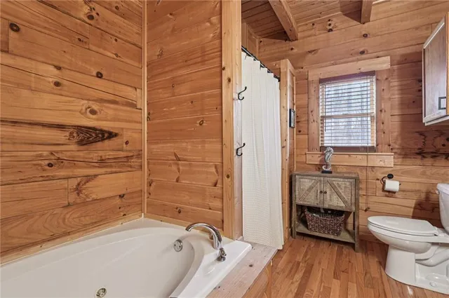 a bathroom with a tub toilet and sink