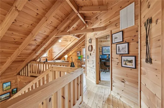 a view of staircase with lots of frames on wall and a large window