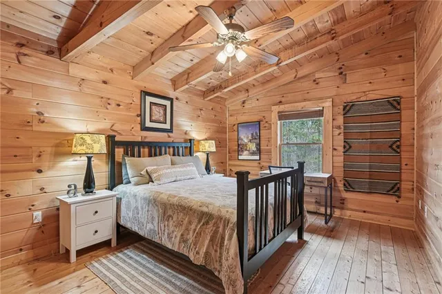 a bedroom with a bed next to a large window with the outer view