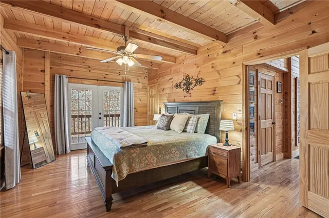 a bedroom with a large bed and a chandelier