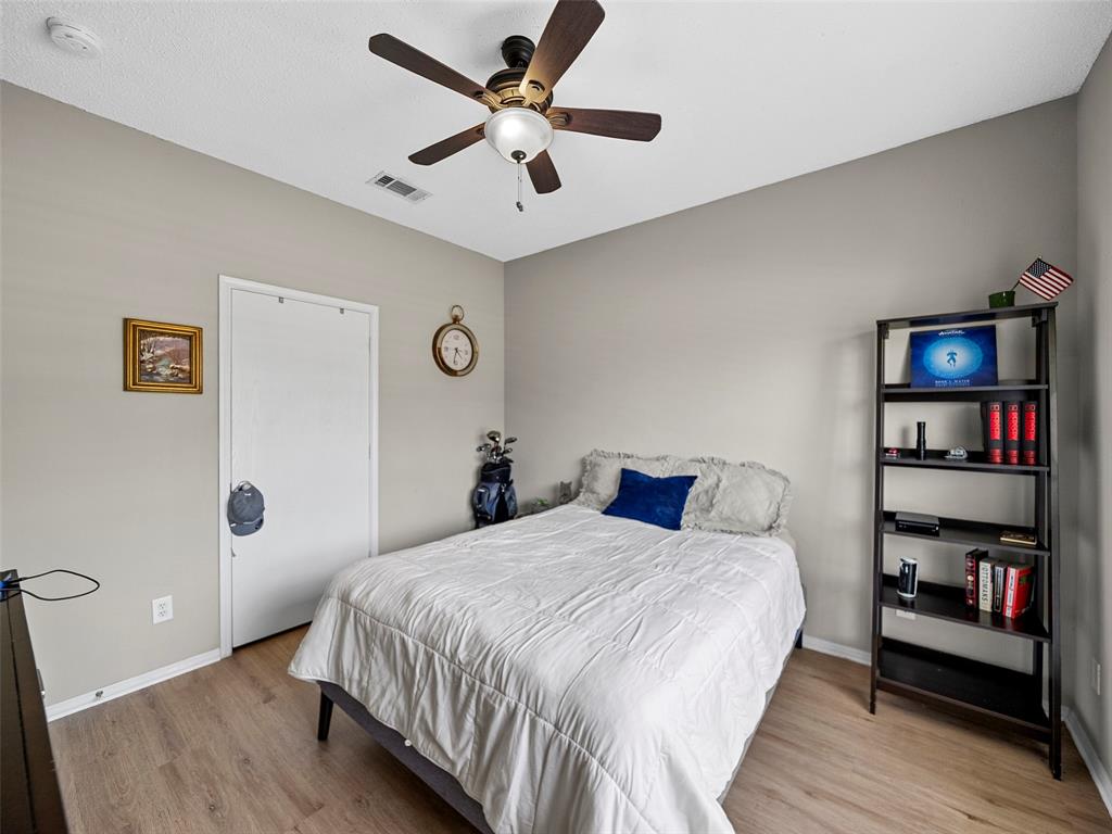 204 Arbor Ridge Drive Allen, TX 75002 - Photo 25 of 36 Spacious room - Bedroom 3 featuring wood-finish flooring, a ceiling fan with integrated lighting, and a neutral wall color