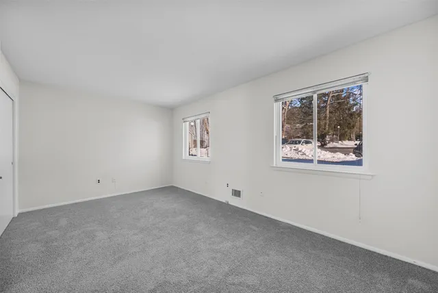 an empty room with a painting on the wall