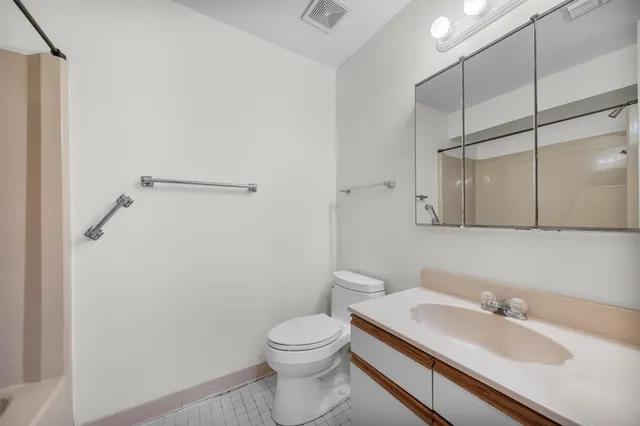 a bathroom with a toilet and a bathtub
