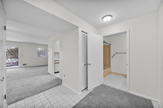 a view of a livingroom with a ceiling fan and window