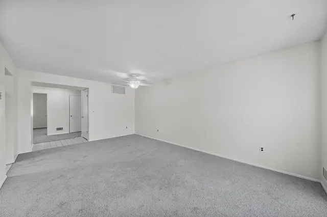 a kitchen with a refrigerator sink and cabinets