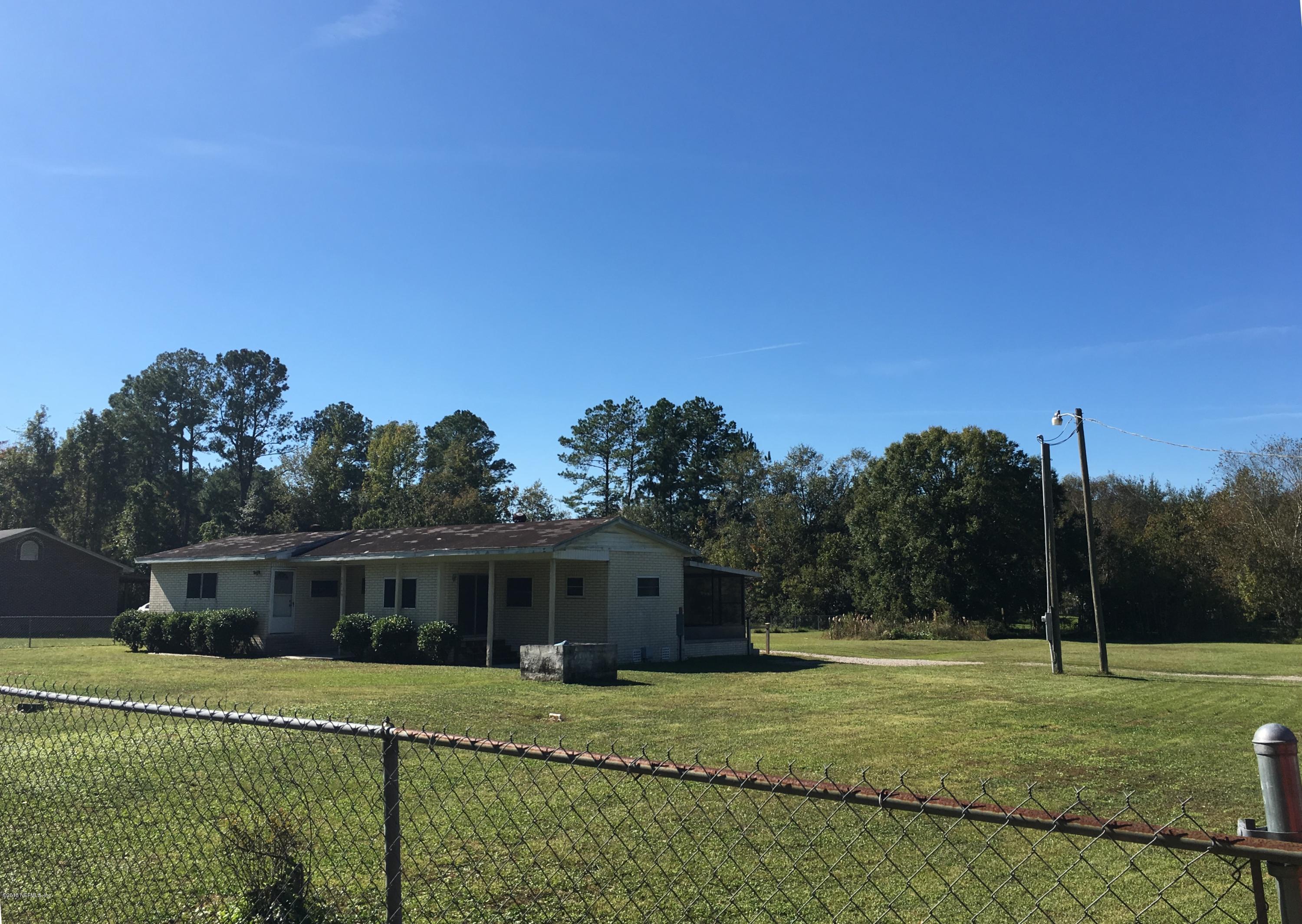 54199 Roy Booth Road Callahan, FL 32011 - Photo 1 of 23 a front view of a house with a yard
