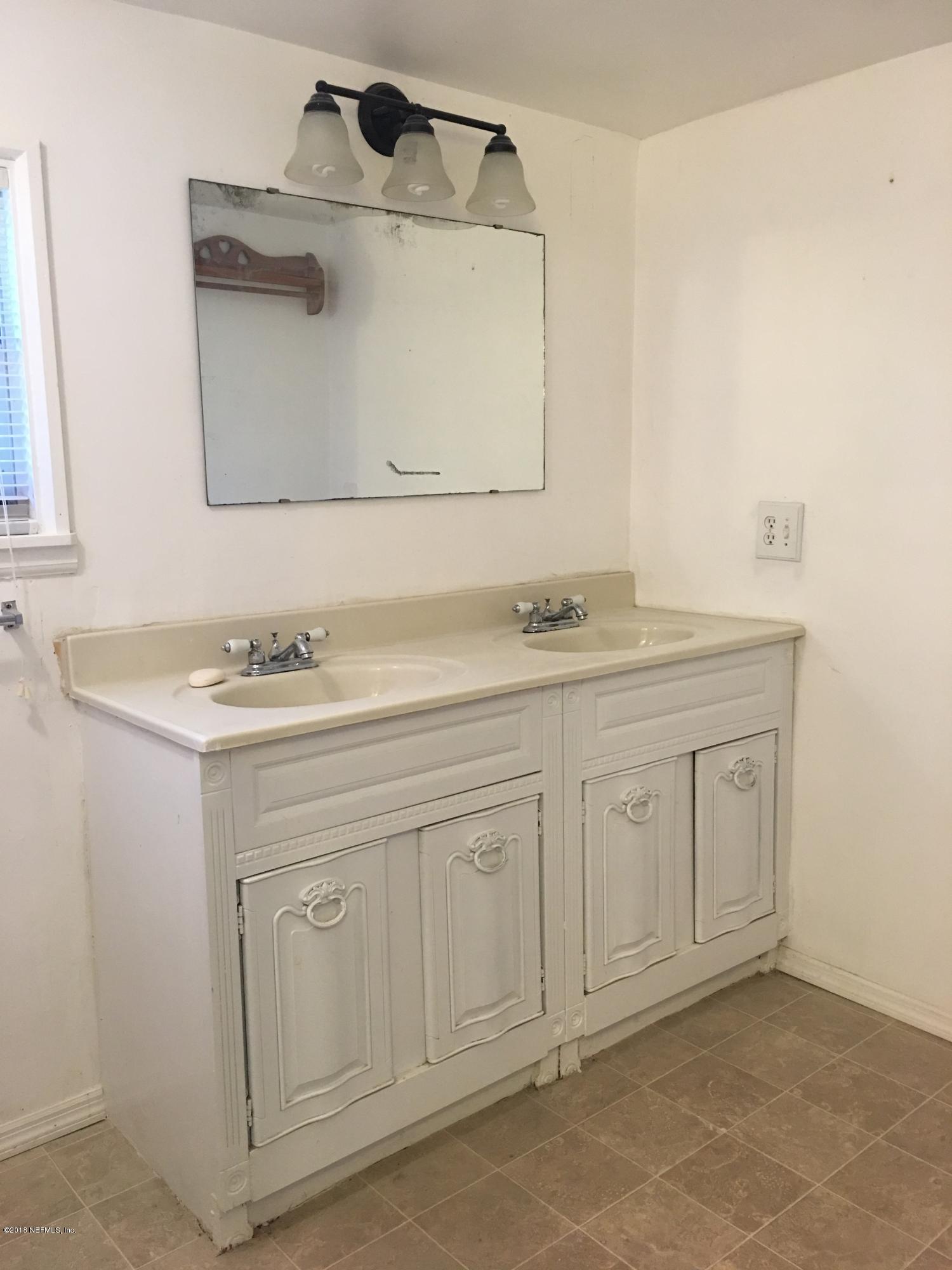 54199 Roy Booth Road Callahan, FL 32011 - Photo 13 of 23 a bathroom with a sink and a mirror