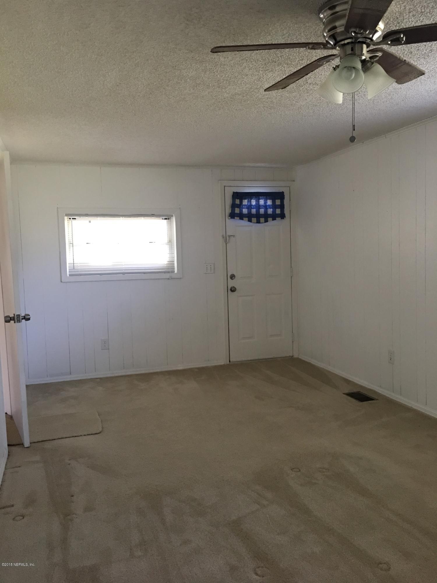 54199 Roy Booth Road Callahan, FL 32011 - Photo 18 of 23 an empty room with a ceiling fan and window