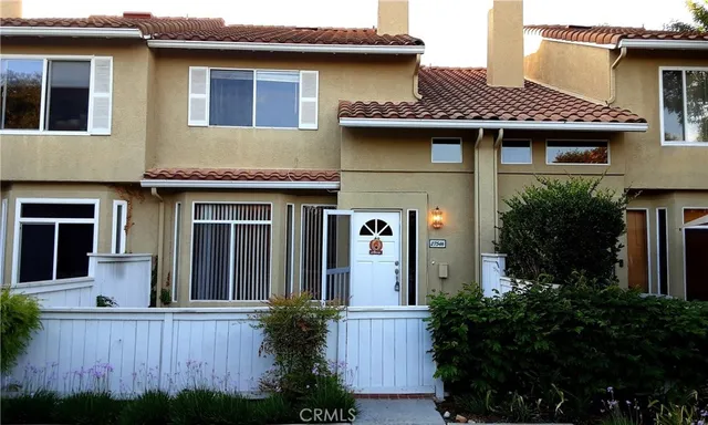 a front view of a house with plants