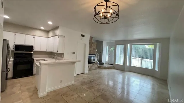a view of a kitchen with a sink dishwasher and a refrigerator