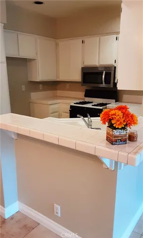 a kitchen with stainless steel appliances a cabinets and a stove top oven