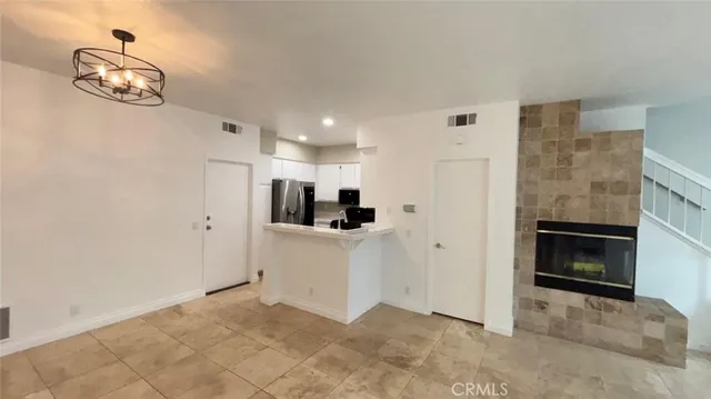 a view of kitchen cabinet and refrigerator
