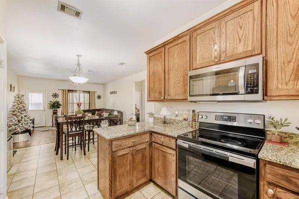 a kitchen with appliances a stove cabinets and a kitchen island