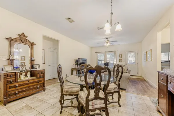 a view of a dining room with furniture and chandelier