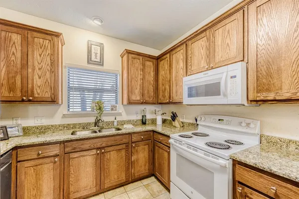 a kitchen with stainless steel appliances granite countertop a sink stove and cabinets