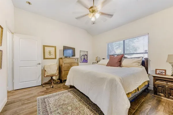 a bedroom with a bed and a chandelier