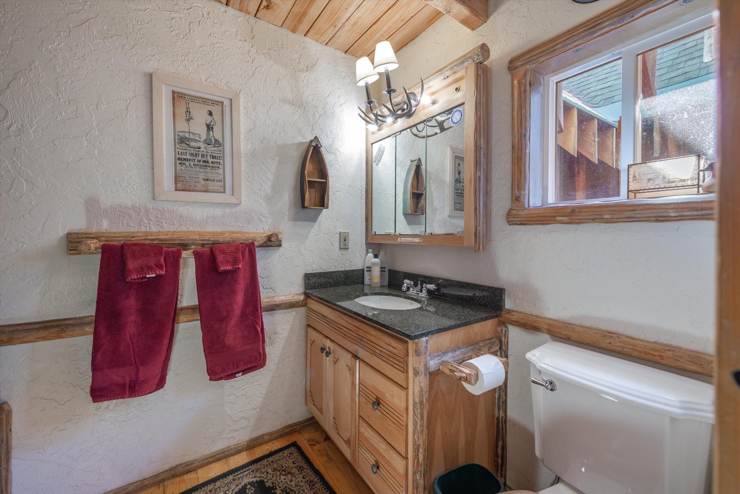8600 Cold Stream Road Truckee, CA 96161 - Photo 12 of 28 a bathroom with a sink a vanity and mirror