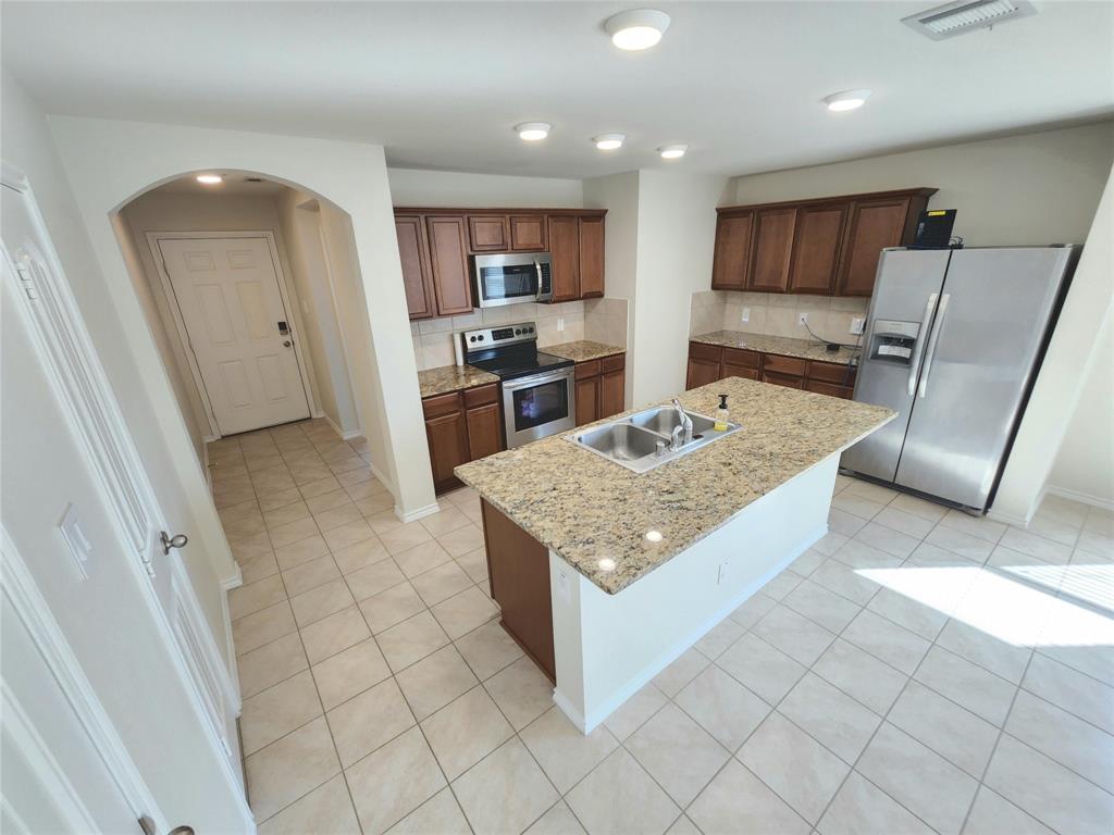 924 Amber Street Princeton, TX 75407 - Photo 5 of 19 Kitchen and Entrance